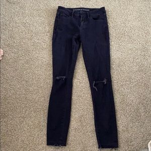 Low-waisted ripped jeans
